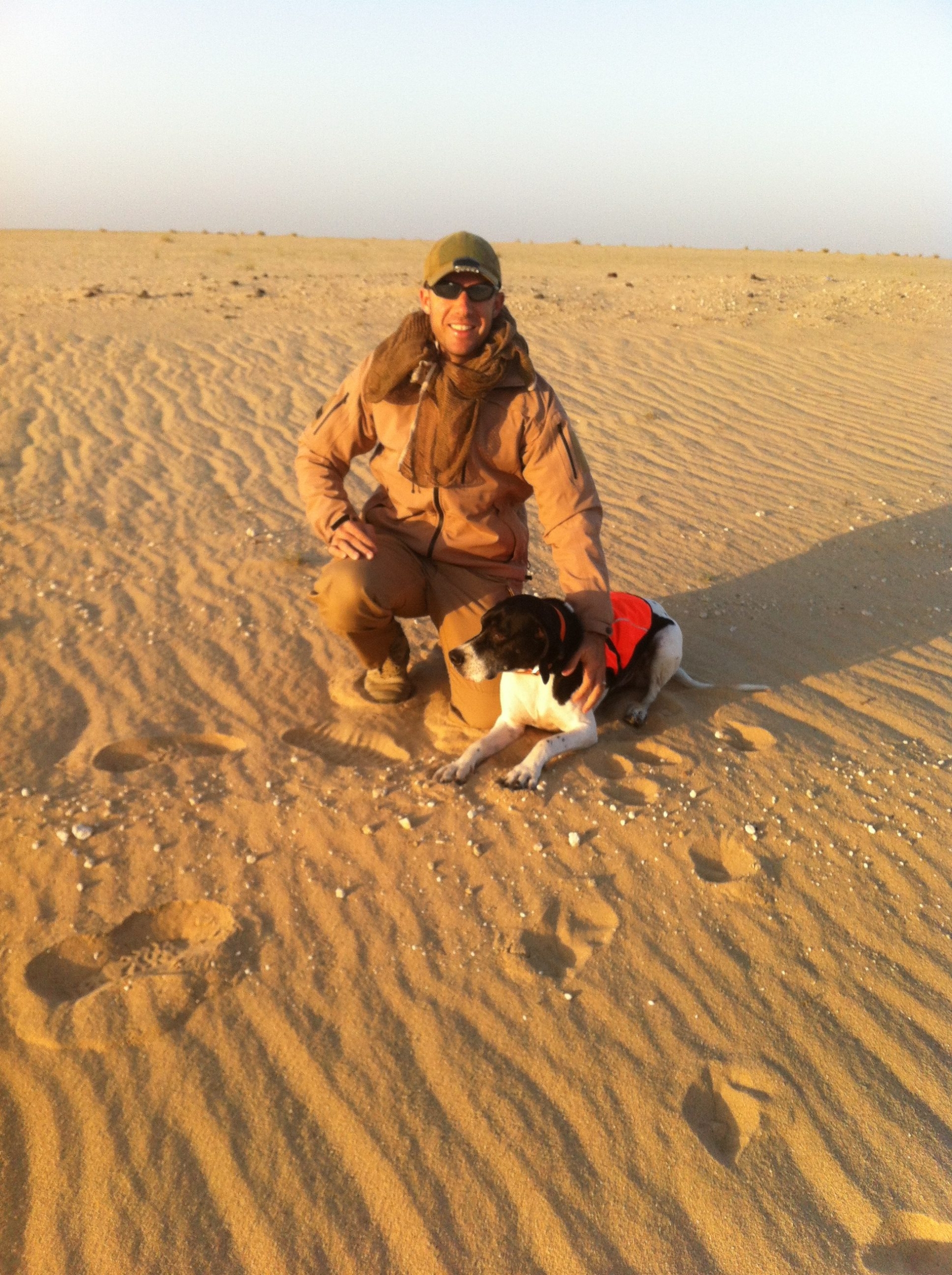 animal control officer with dog in desert