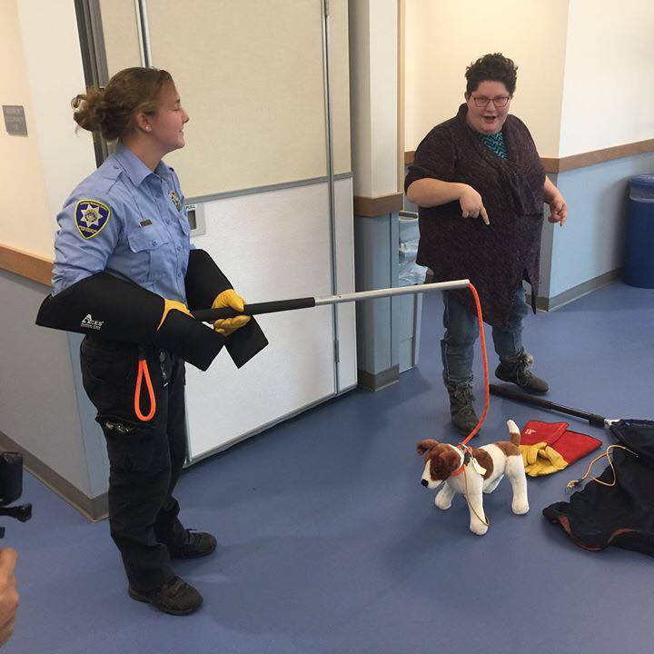 animal control officer demonstrating catching pole for dogs